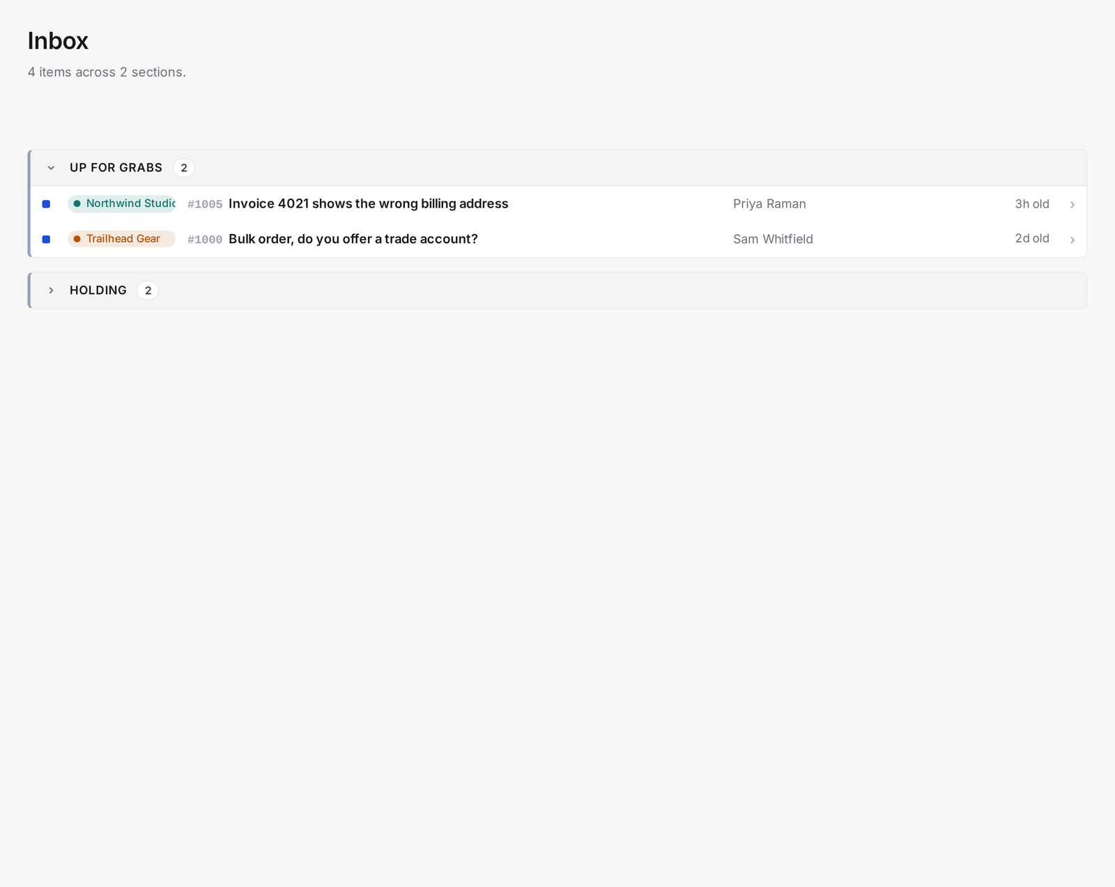 The inbox priority queue with Awaiting your reply, Up for grabs, and a collapsed Holding section, each showing ticket counts